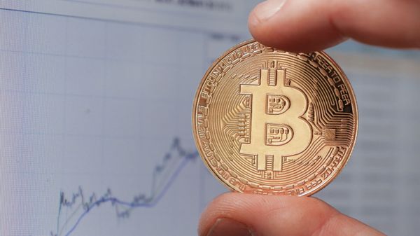 Монета с логотипом криптовалюты биткоин