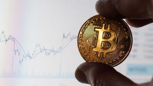 Монета с логотипом криптовалюты биткоин