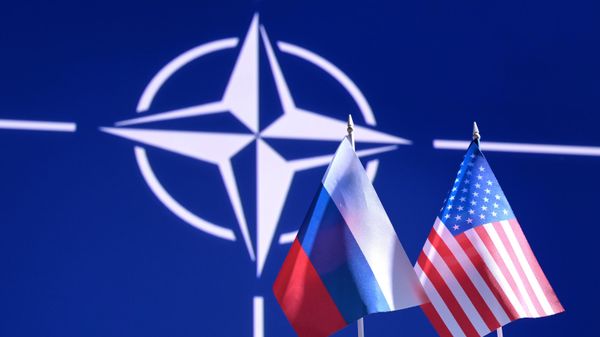Флаги России и США на фоне логотипа НАТО