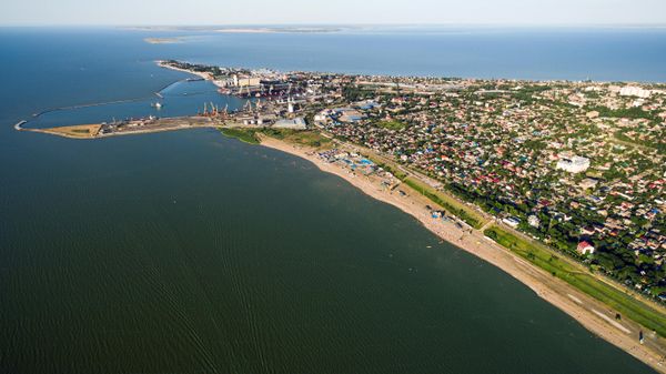 Ейский морской торговый порт и городская застройка на Ейской косе между Таганрогским заливом и Ейским лиманом Азовского моря